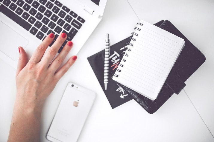 woman-hand-smartphone-desk-pexels